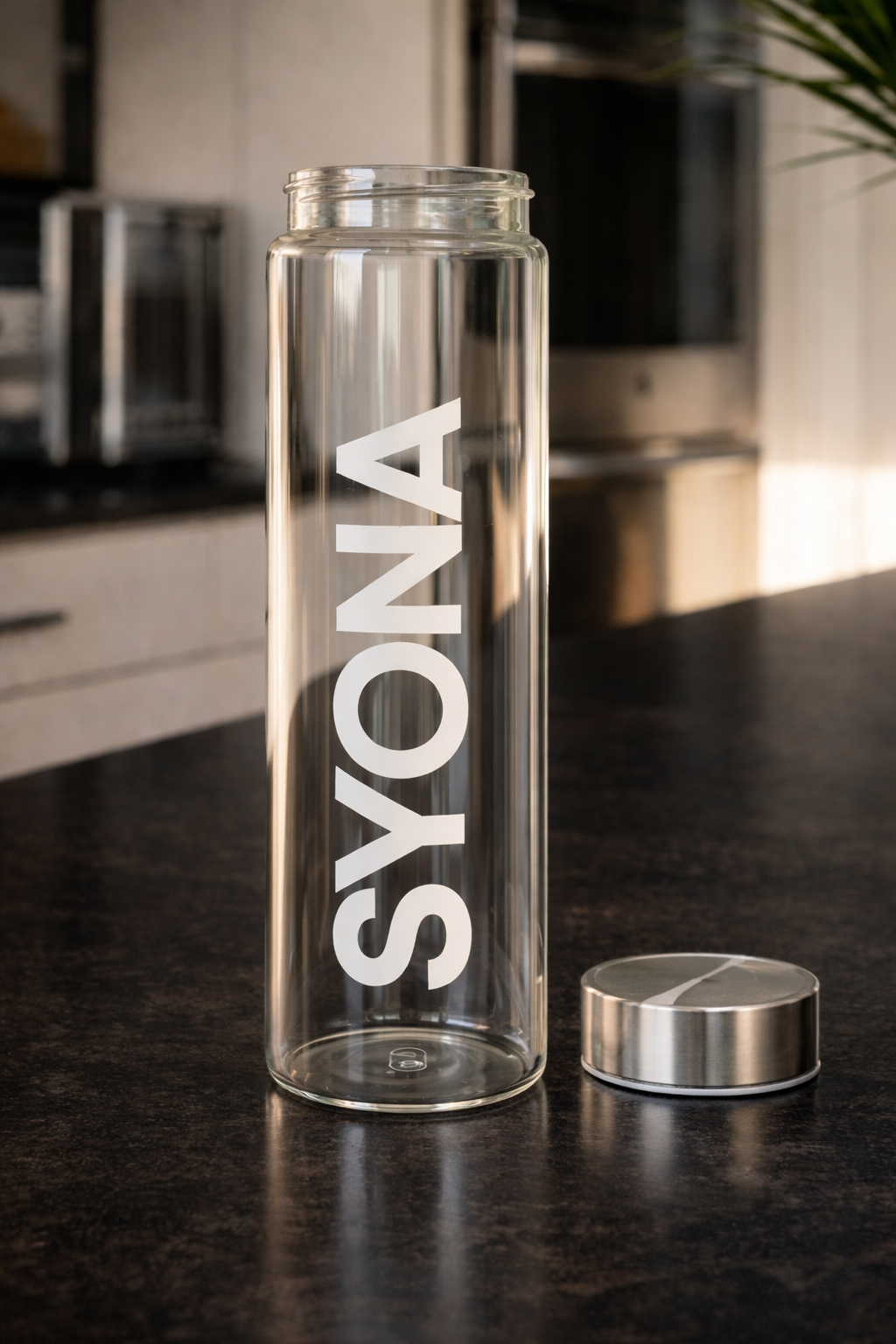 Before — photo of an empty Syona glass bottle on a kitchen counter
